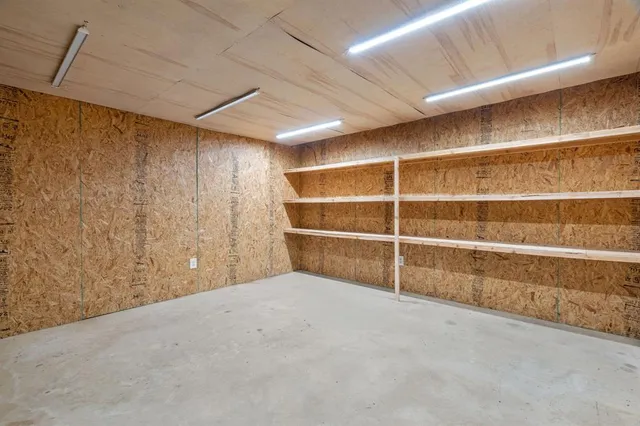 a view of a house with a wooden fence