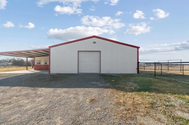 a large kitchen with a stove a refrigerator and a microwave oven