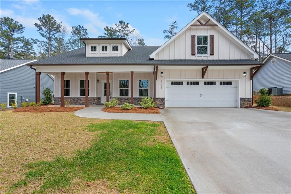 6093 Wayfarer Drive Villa Rica, GA 30180 - Photo 1 of 70 a view of a white house with large windows and a table and chairs