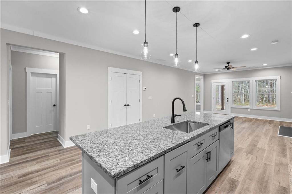 6093 Wayfarer Drive Villa Rica, GA 30180 - Photo 16 of 70 a kitchen with granite countertop a stove a sink a oven and a granite counter tops