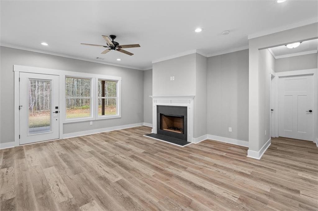 6093 Wayfarer Drive Villa Rica, GA 30180 - Photo 17 of 70 a view of an empty room with wooden floor fireplace and a window