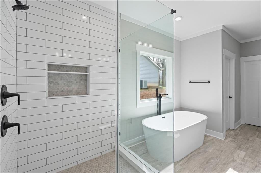 6093 Wayfarer Drive Villa Rica, GA 30180 - Photo 25 of 70 a bathroom with a tub and a shower