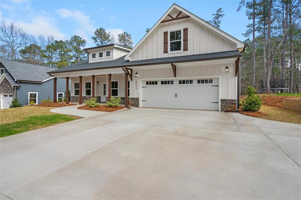6093 Wayfarer Drive Villa Rica, GA 30180 - Photo 5 of 70 a view of a white house with a big yard and large tree