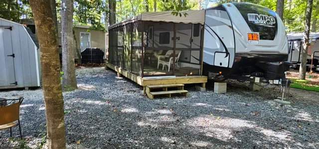 a backyard of a house with barbeque oven table and chairs