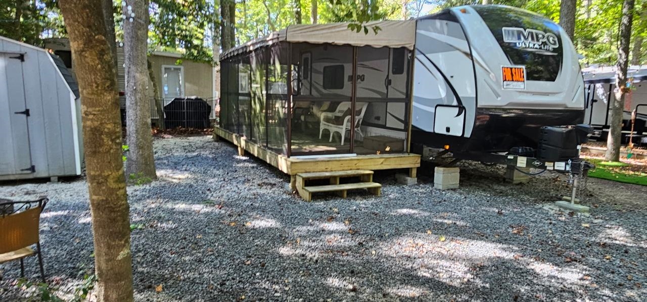 a backyard of a house with barbeque oven table and chairs