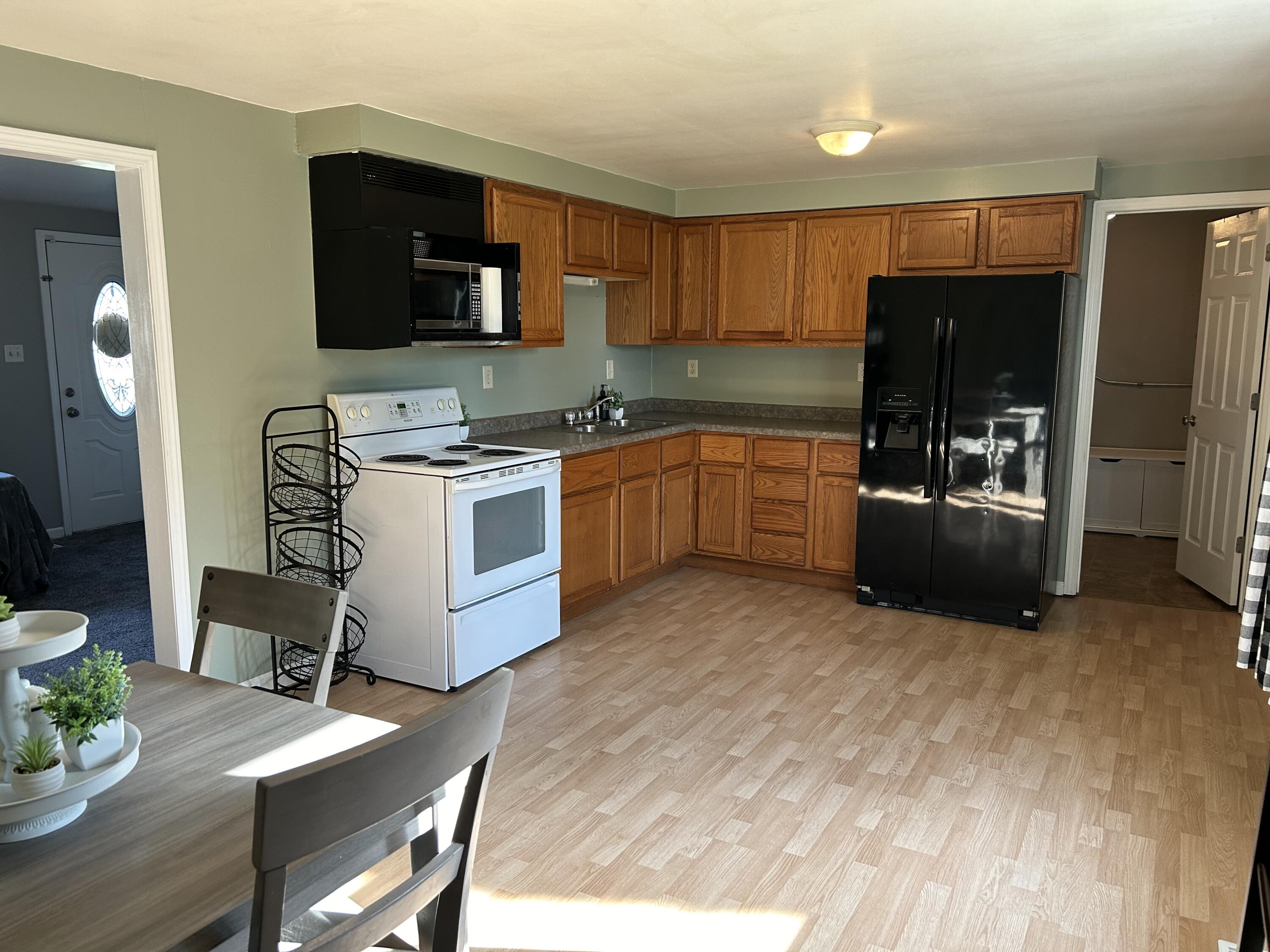 502 North Webster Street Rensselaer, IN 47978 - Photo 6 of 35 a kitchen with stainless steel appliances granite countertop a stove refrigerator and microwave