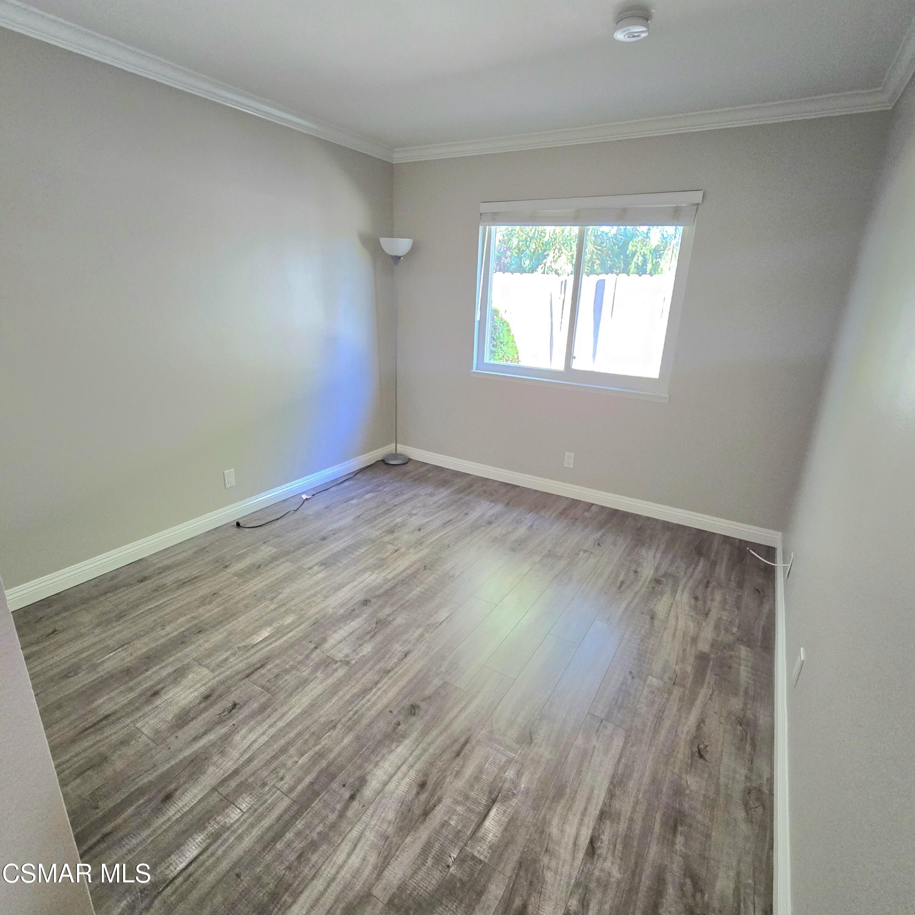 13568 East Quail Summit Road Moorpark, CA 93021 - Photo 12 of 20 a view of an empty room with wooden floor and a window