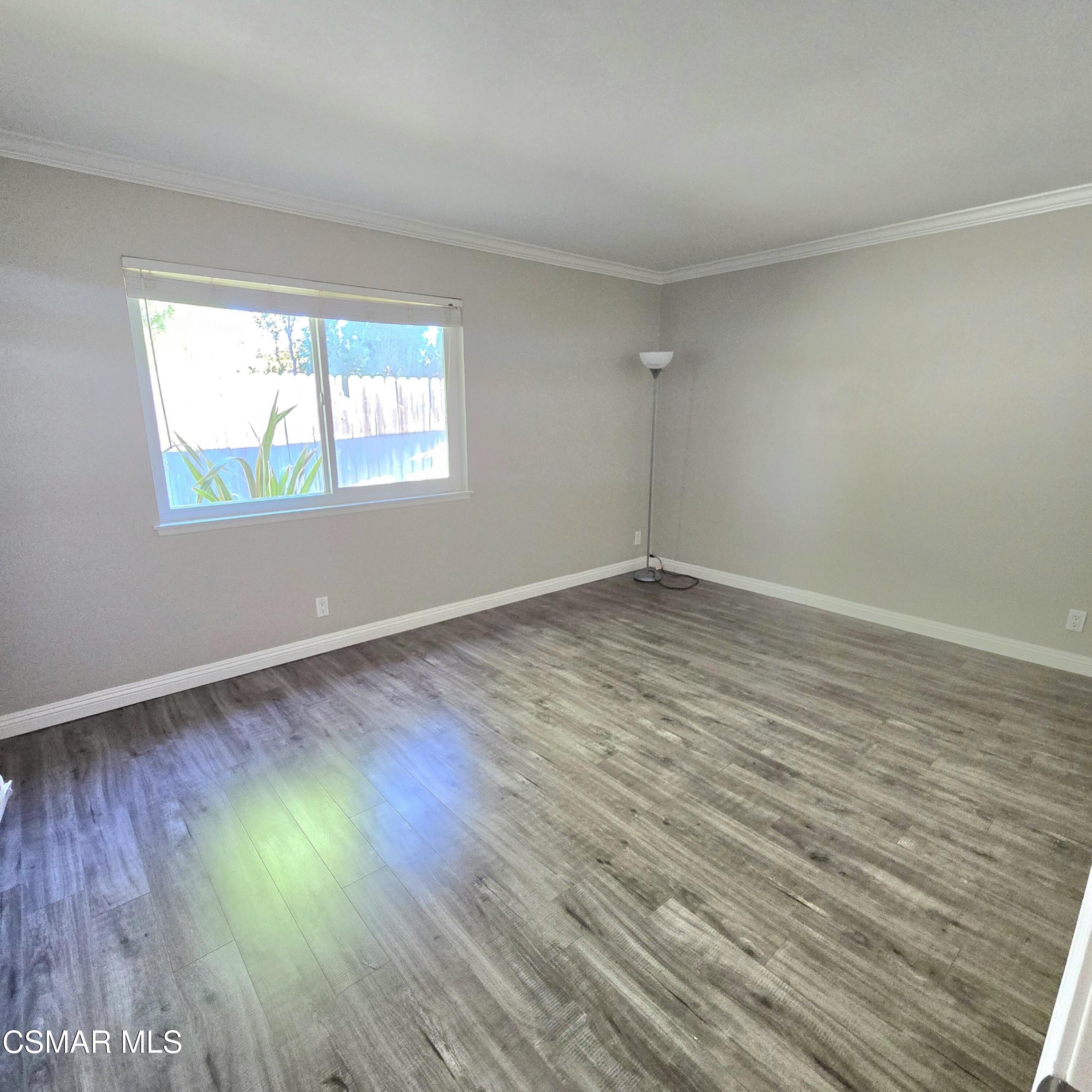 13568 East Quail Summit Road Moorpark, CA 93021 - Photo 15 of 20 a view of an empty room with wooden floor and a window