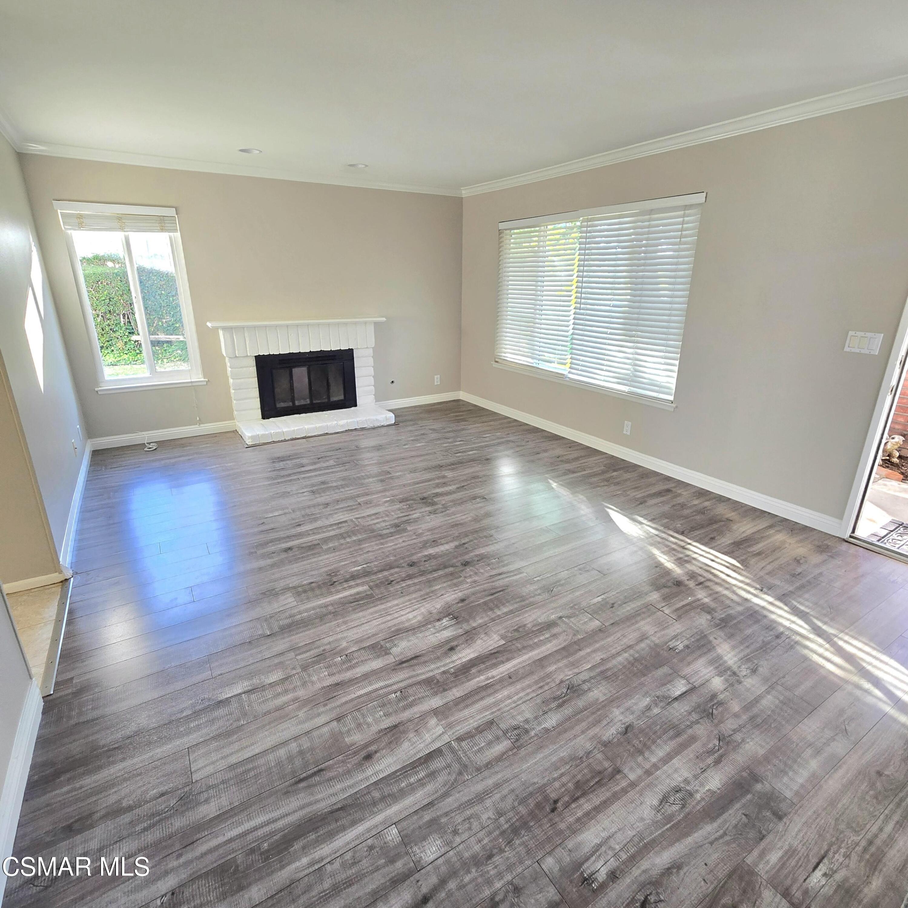 13568 East Quail Summit Road Moorpark, CA 93021 - Photo 3 of 20 an empty room with wooden floor and windows