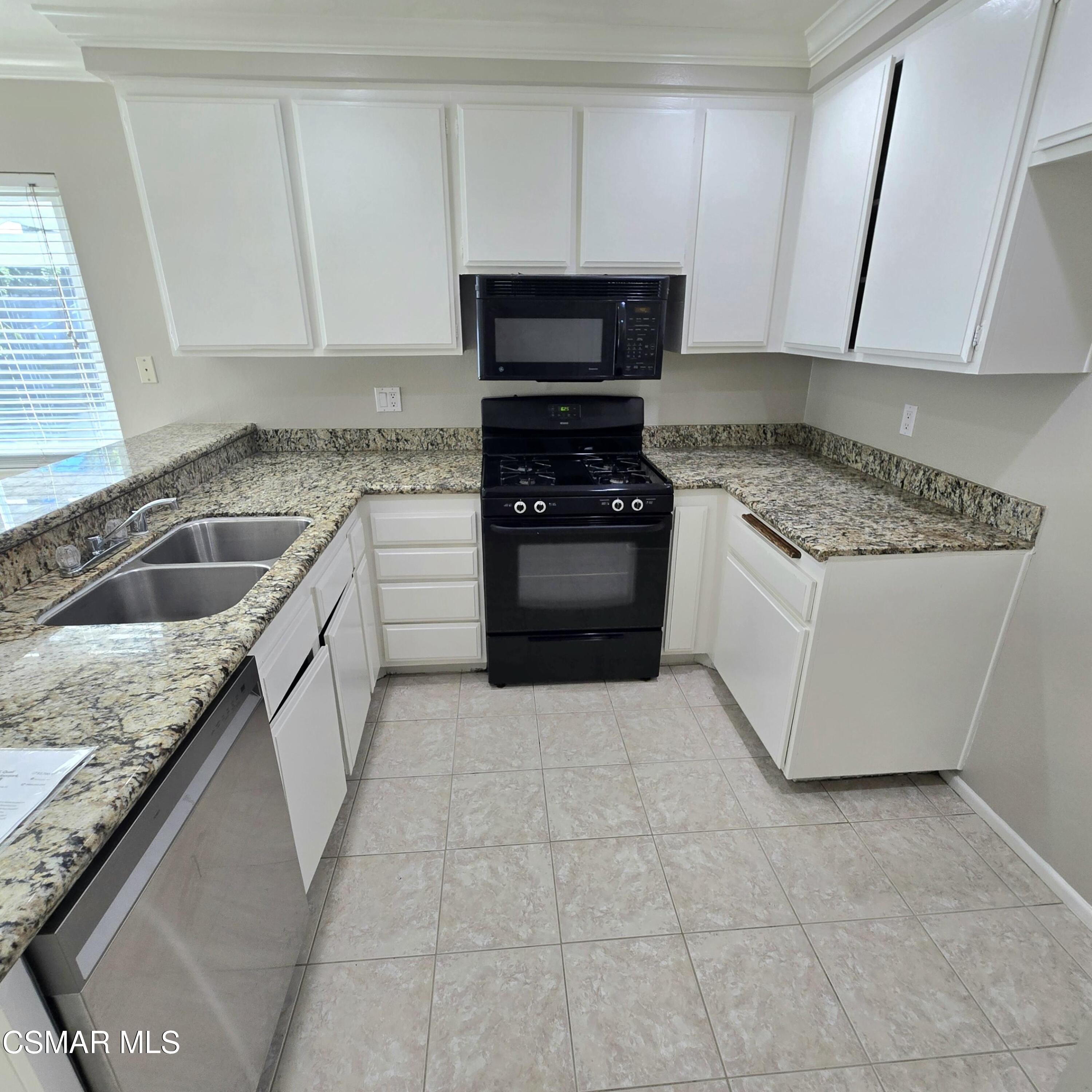 13568 East Quail Summit Road Moorpark, CA 93021 - Photo 4 of 20 a kitchen with granite countertop a sink and stainless steel appliances