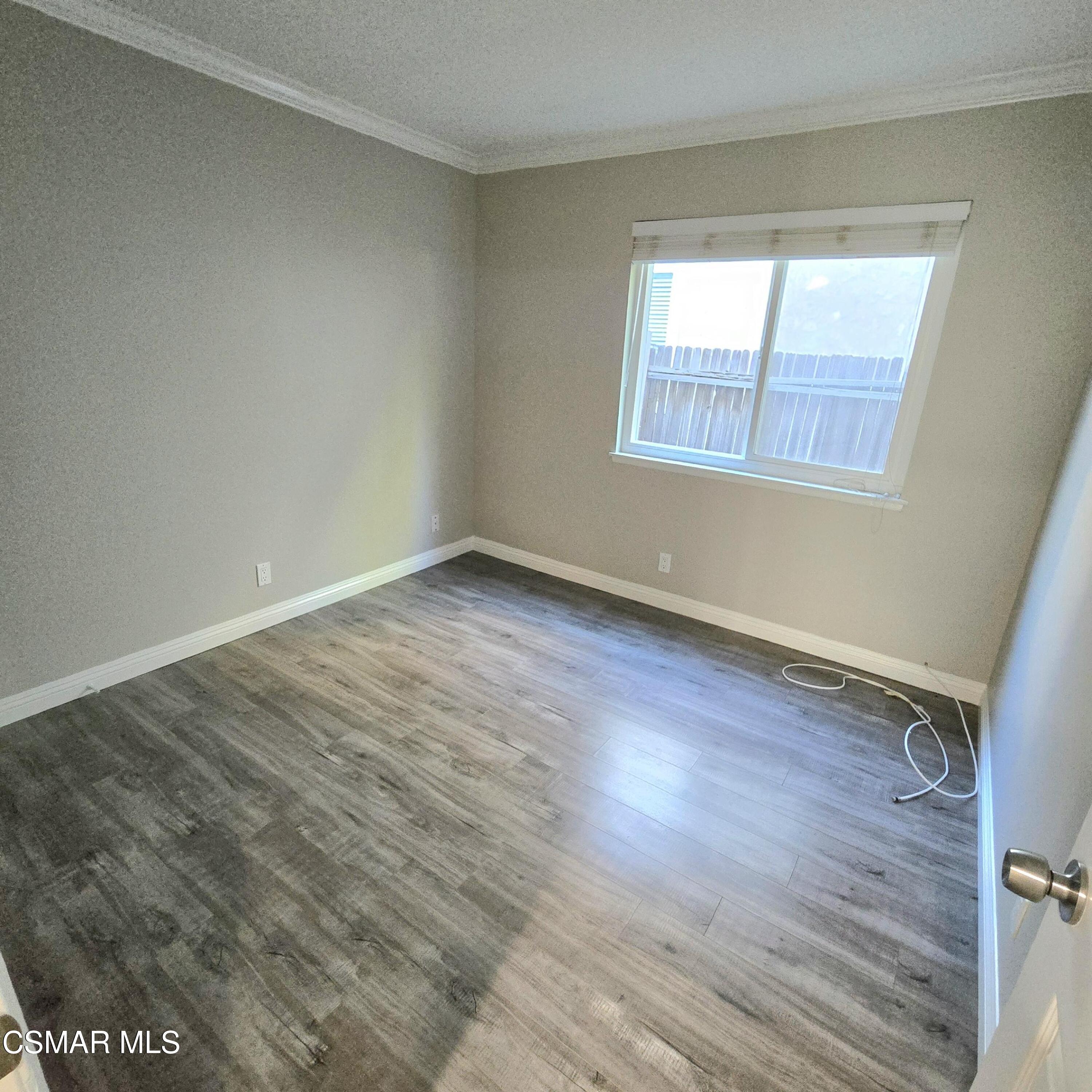 13568 East Quail Summit Road Moorpark, CA 93021 - Photo 10 of 20 a view of an empty room with wooden floor and a window
