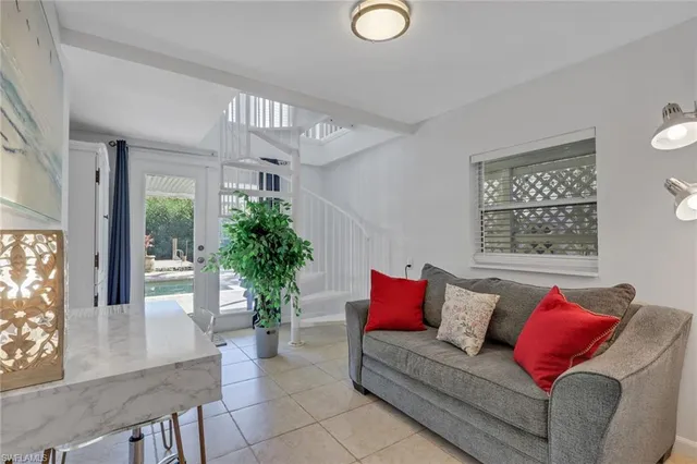 a living room with furniture and a potted plant