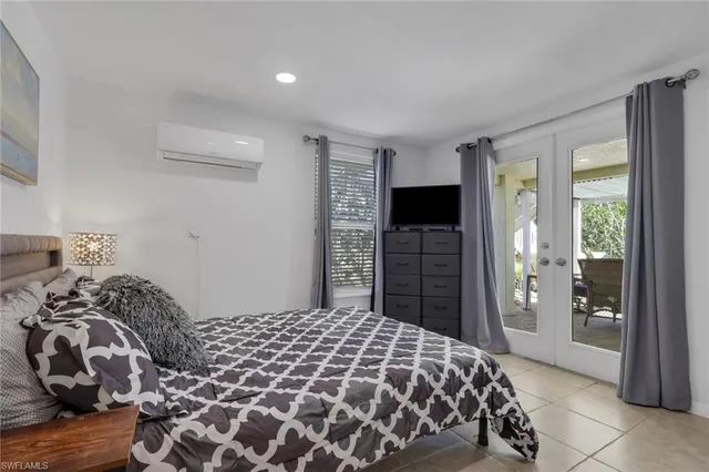 a bedroom with a large bed and a tv