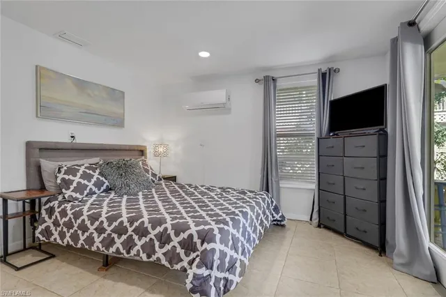 a bedroom with a bed and flat screen tv