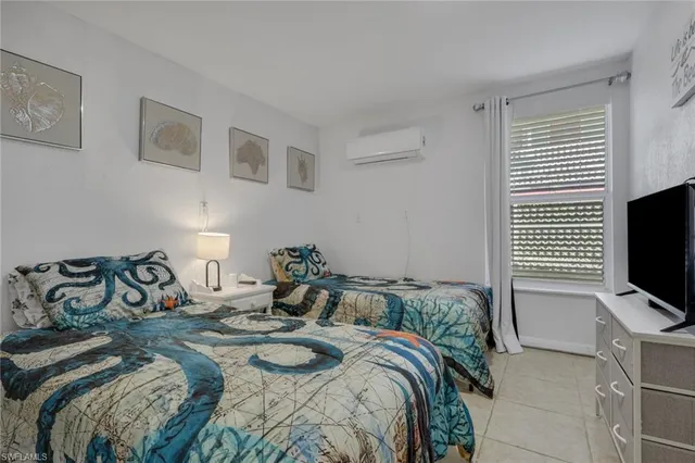 a bedroom with a bed and flat screen tv