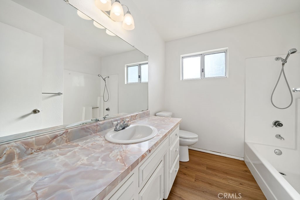 1766 Shepherd Drive Paso Robles, CA 93446 - Photo 28 of 29 a bathroom with a granite countertop sink a toilet a bathtub and shower