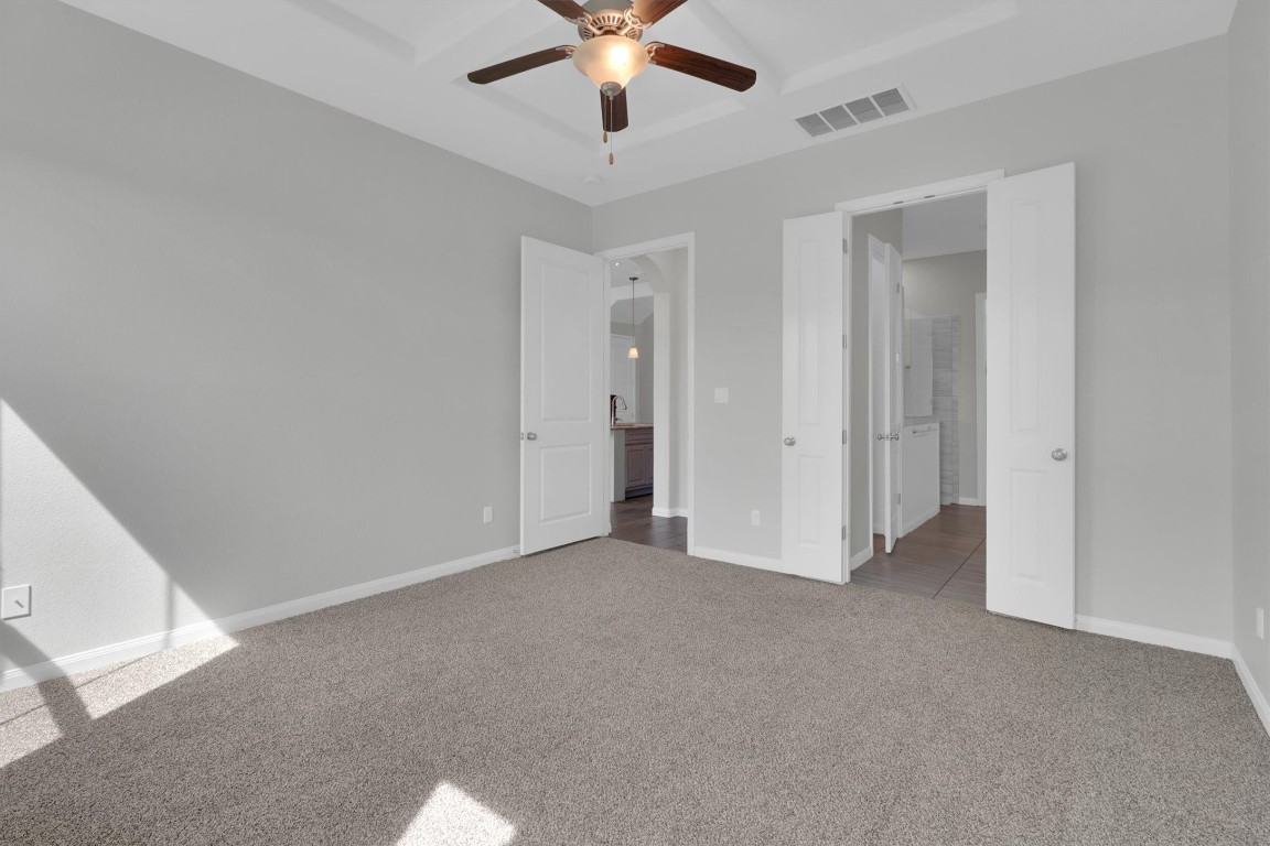 201 Cartwheel Bend, Unit 30 Austin, TX 78738 - Photo 11 of 40 a view of an empty room with a ceiling fan