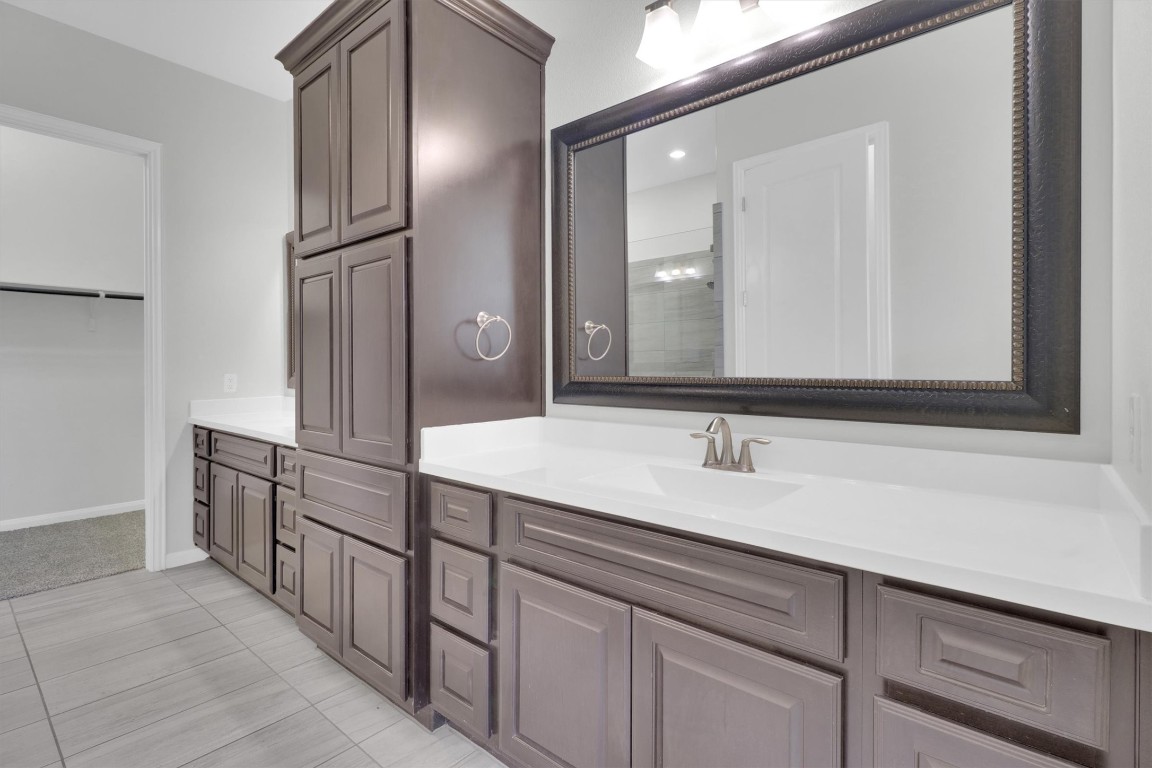 201 Cartwheel Bend, Unit 30 Austin, TX 78738 - Photo 12 of 40 a bathroom with a sink and a mirror