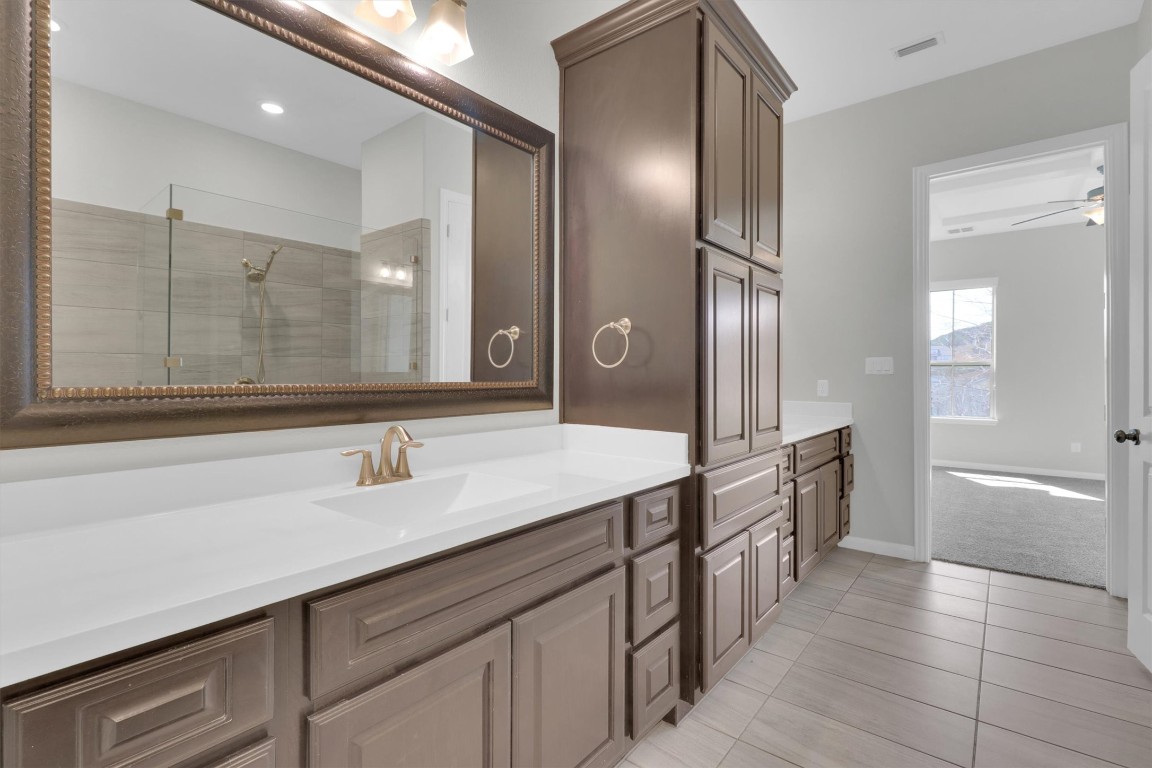 201 Cartwheel Bend, Unit 30 Austin, TX 78738 - Photo 13 of 40 a spacious bathroom with a double vanity sink a large mirror and a bathtub
