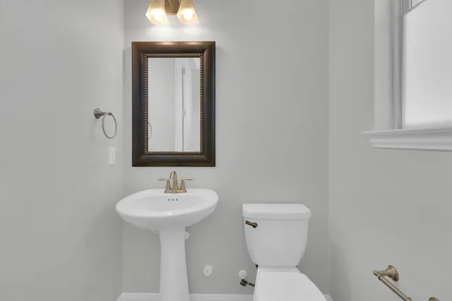 a spacious bathroom with a double vanity sink a large mirror and a bathtub
