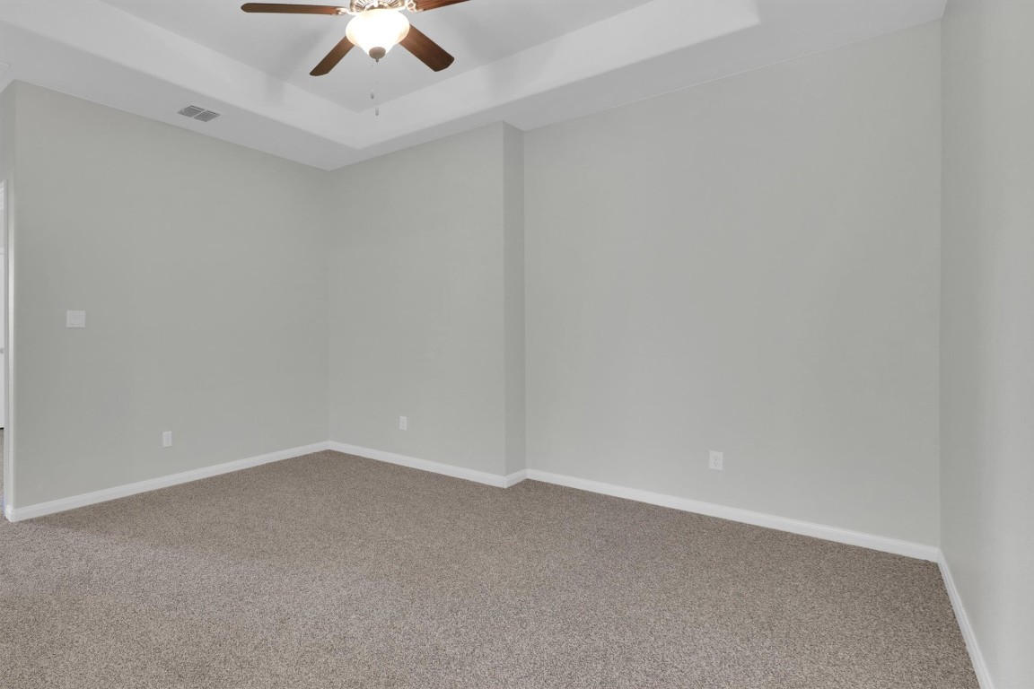 201 Cartwheel Bend, Unit 30 Austin, TX 78738 - Photo 16 of 40 an empty room with a ceiling fan and carpet