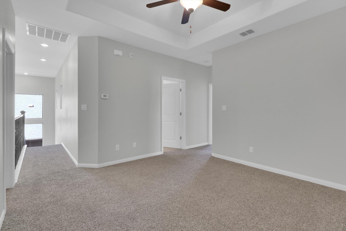 201 Cartwheel Bend, Unit 30 Austin, TX 78738 - Photo 18 of 40 en empty room with fan and entrance