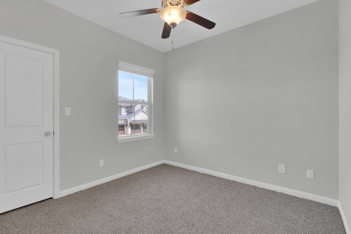201 Cartwheel Bend, Unit 30 Austin, TX 78738 - Photo 21 of 40 an empty room with a window and a fan
