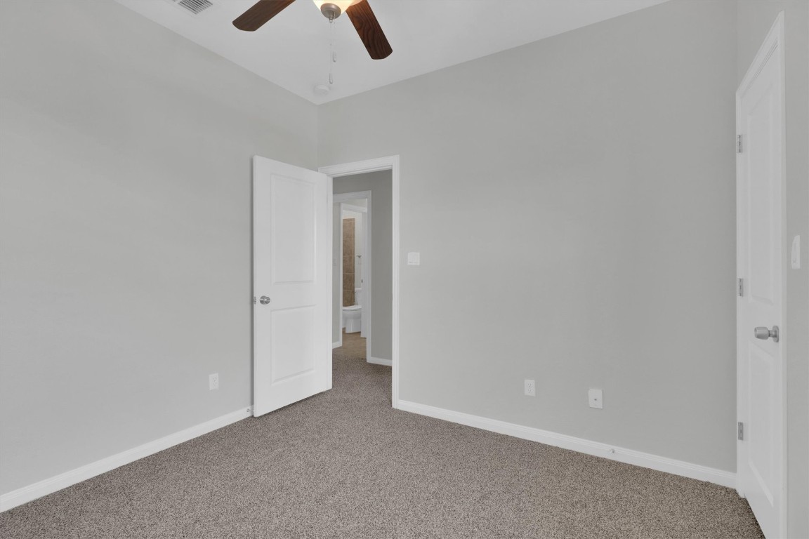 201 Cartwheel Bend, Unit 30 Austin, TX 78738 - Photo 22 of 40 an empty room with closet and a ceiling fan