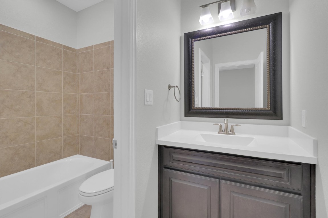201 Cartwheel Bend, Unit 30 Austin, TX 78738 - Photo 25 of 40 a bathroom with a sink a toilet and shower