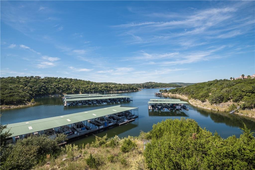 201 Cartwheel Bend, Unit 30 Austin, TX 78738 - Photo 37 of 40 a view of a lake with houses in the back
