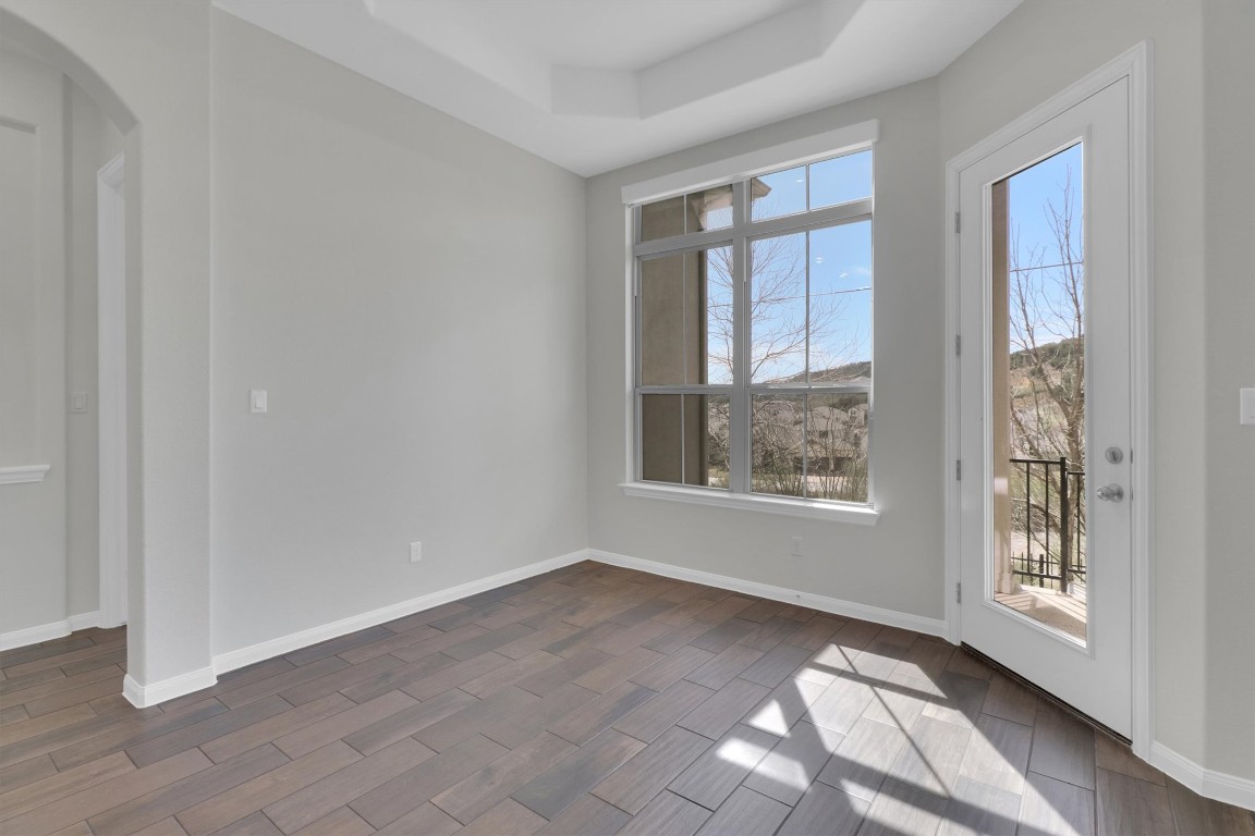 201 Cartwheel Bend, Unit 30 Austin, TX 78738 - Photo 5 of 40 a view of an empty room with a window and wooden floor