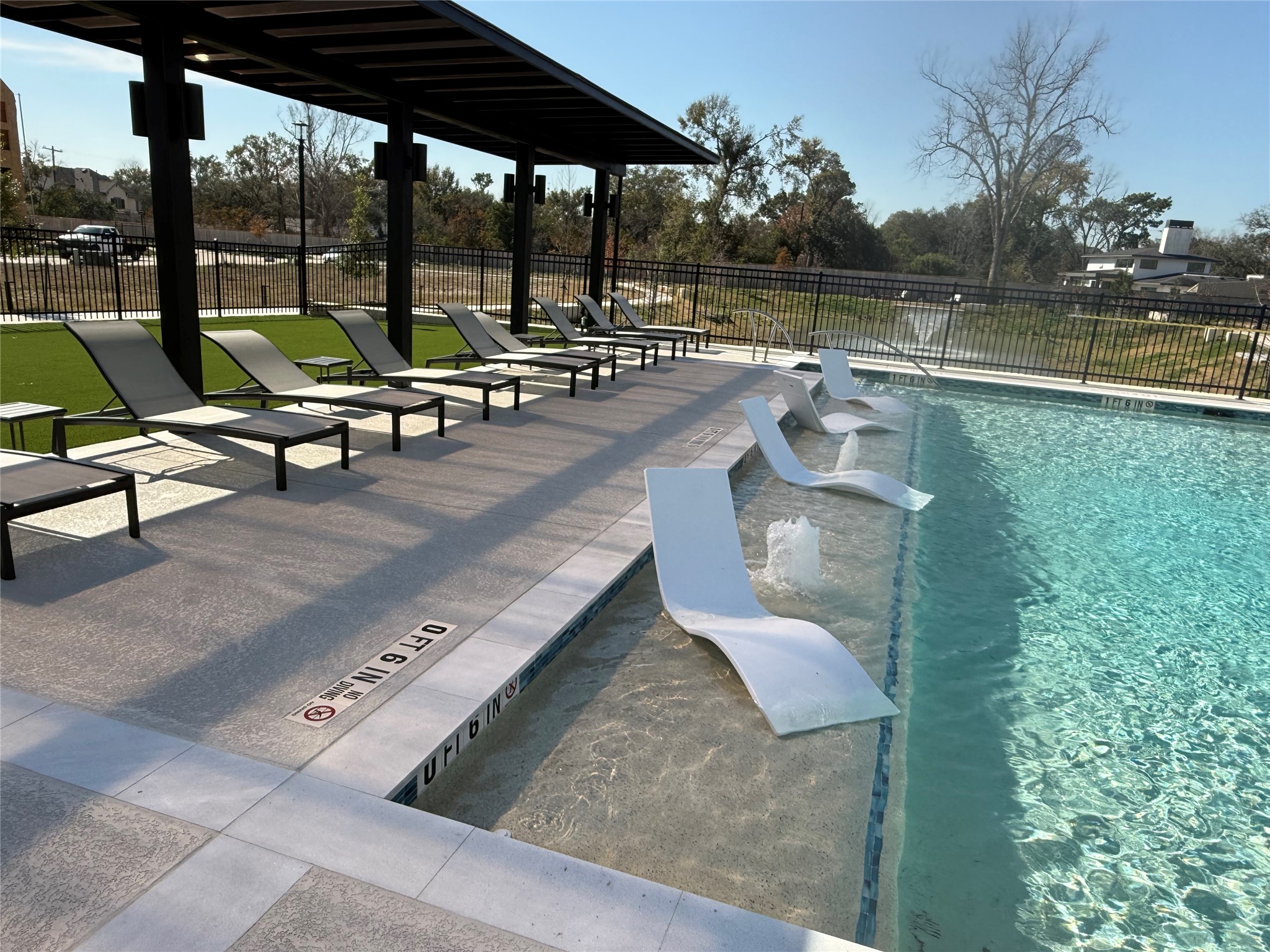 8705 Cosenza Lane Houston, TX 77055 - Photo 8 of 12 a view of a swimming pool with a lounge chairs