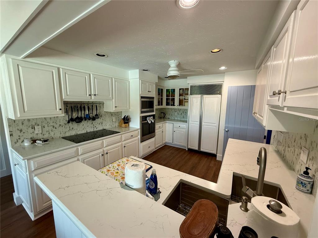 3534 Casey Key Road Nokomis, FL 34275 - Photo 14 of 55 a kitchen with stainless steel appliances kitchen island granite countertop a refrigerator and a stove top oven