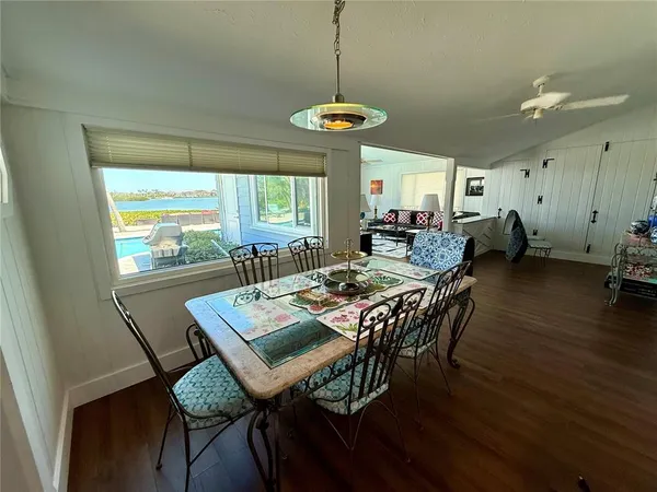 a dining room with furniture and wooden floor