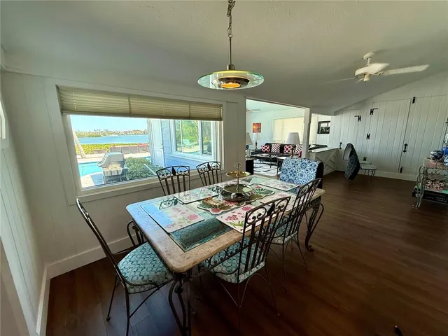 a dining room with furniture and wooden floor