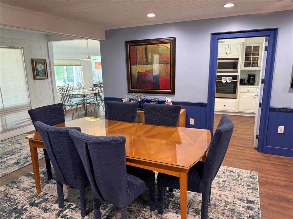 3534 Casey Key Road Nokomis, FL 34275 - Photo 18 of 55 a dining room with furniture and wooden floor