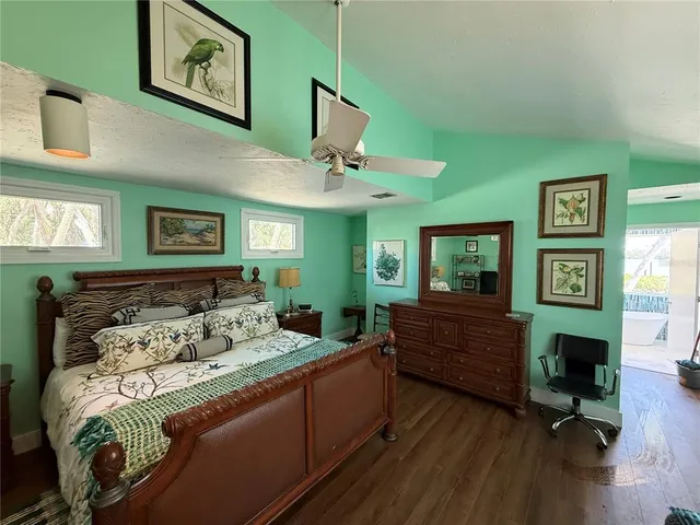 a bedroom with a bed window and a dresser