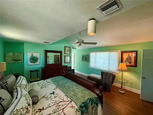 a bathroom with a sink a toilet a mirror and shower