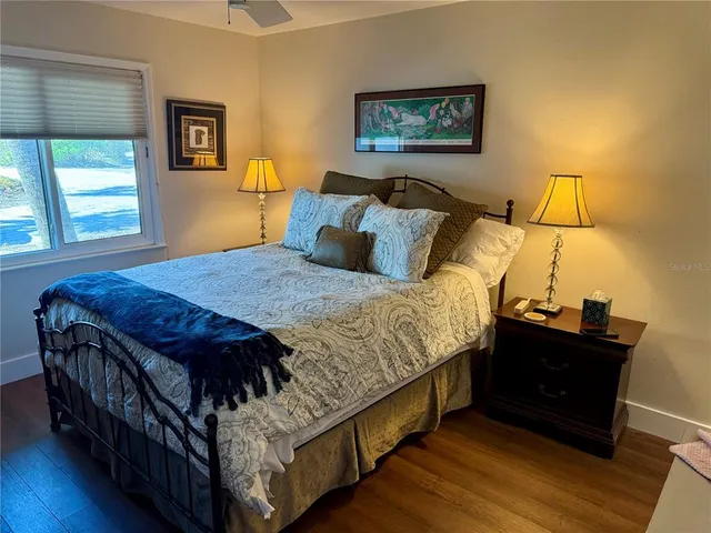 a large bed sitting in a bedroom next to a window
