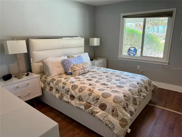 a bedroom with a bed and flat screen tv