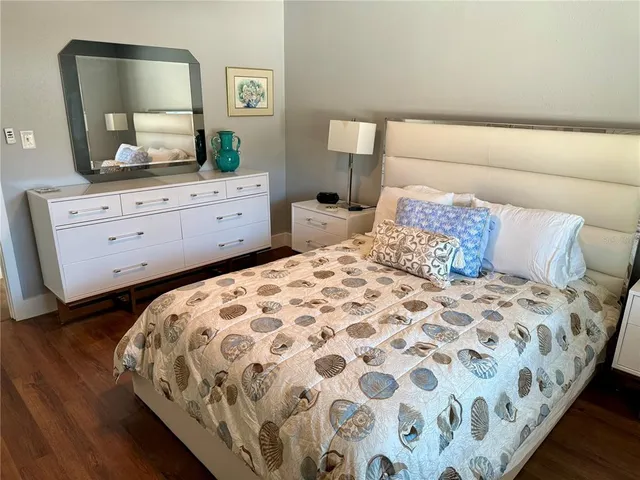 a bedroom with two bed and a desk