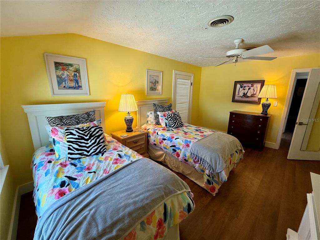 3534 Casey Key Road Nokomis, FL 34275 - Photo 44 of 55 a bedroom with two bed and a desk
