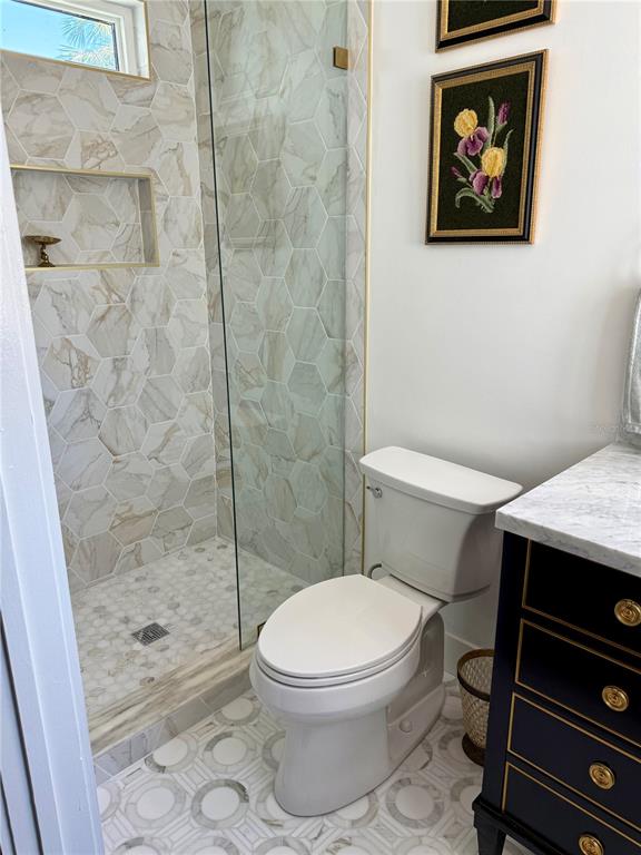 3534 Casey Key Road Nokomis, FL 34275 - Photo 46 of 55 a white toilet and a shower in a bathroom