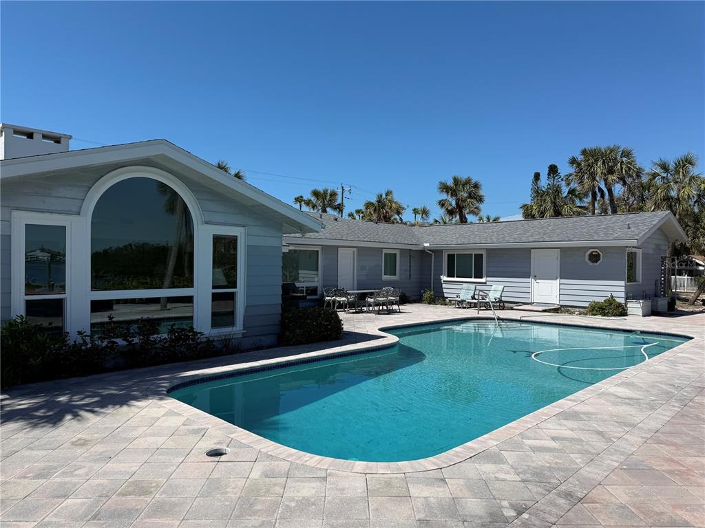 3534 Casey Key Road Nokomis, FL 34275 - Photo 48 of 55 a view of a house with swimming pool and furniture