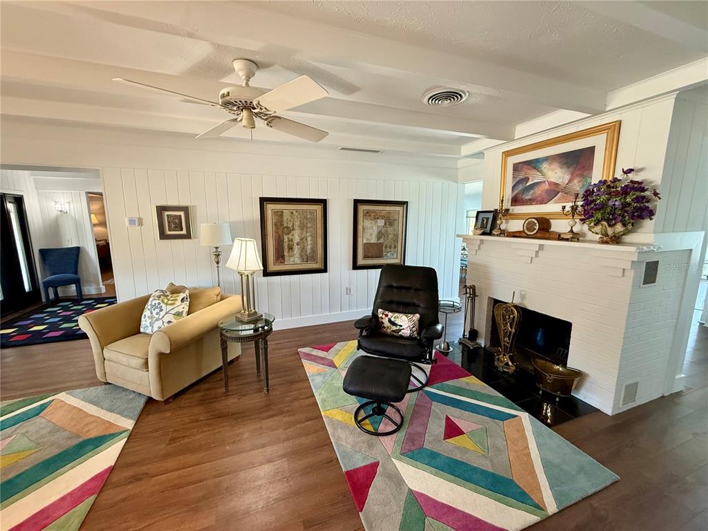 3534 Casey Key Road Nokomis, FL 34275 - Photo 9 of 55 a living room with furniture a fireplace and a flat screen tv