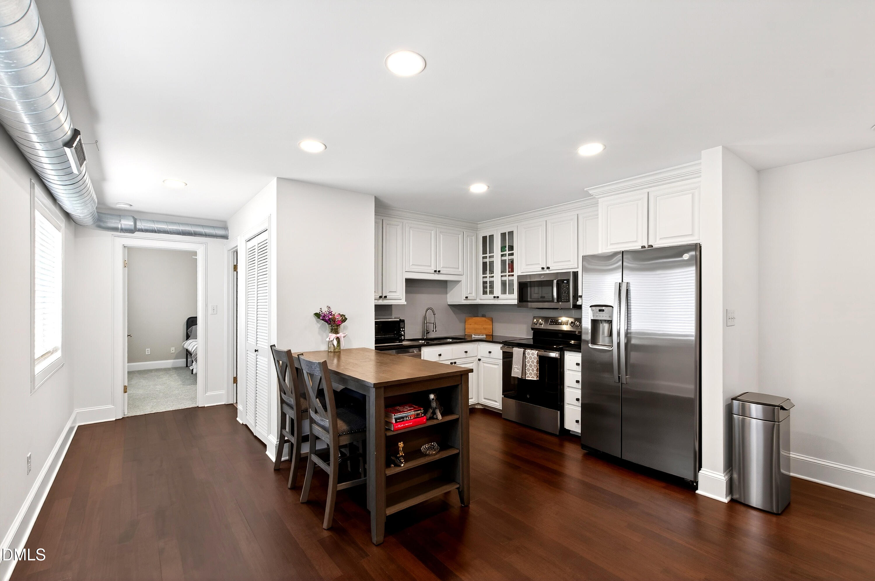 a kitchen with stainless steel appliances a refrigerator a stove top oven and sink