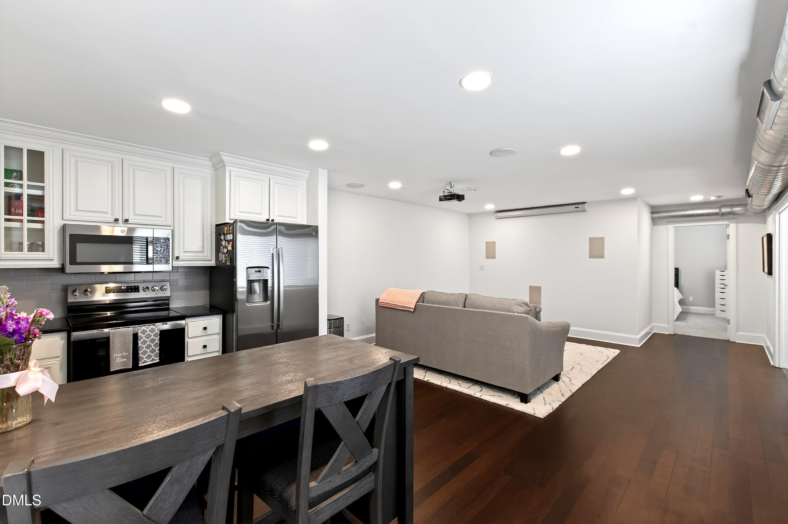 2204 Stafford Avenue, Unit 202 Raleigh, NC 27607 - Photo 7 of 34 a kitchen with stainless steel appliances granite countertop a refrigerator a stove a sink a dining table and chairs