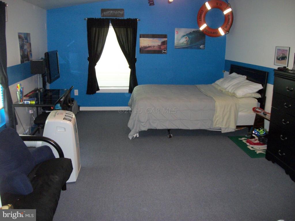 34295-5 5 Bridges Road Princess Anne, MD 21853 - Photo 22 of 26 a bedroom with a bed tv and a window