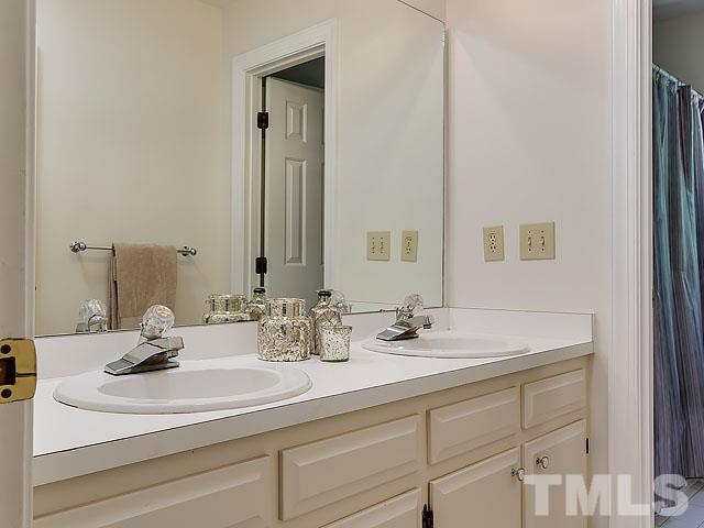 1100 Berwyn Way Raleigh, NC 27615 - Photo 22 of 23 a bathroom with a sink and a mirror