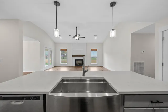 a kitchen with kitchen island a sink appliances and a counter top space